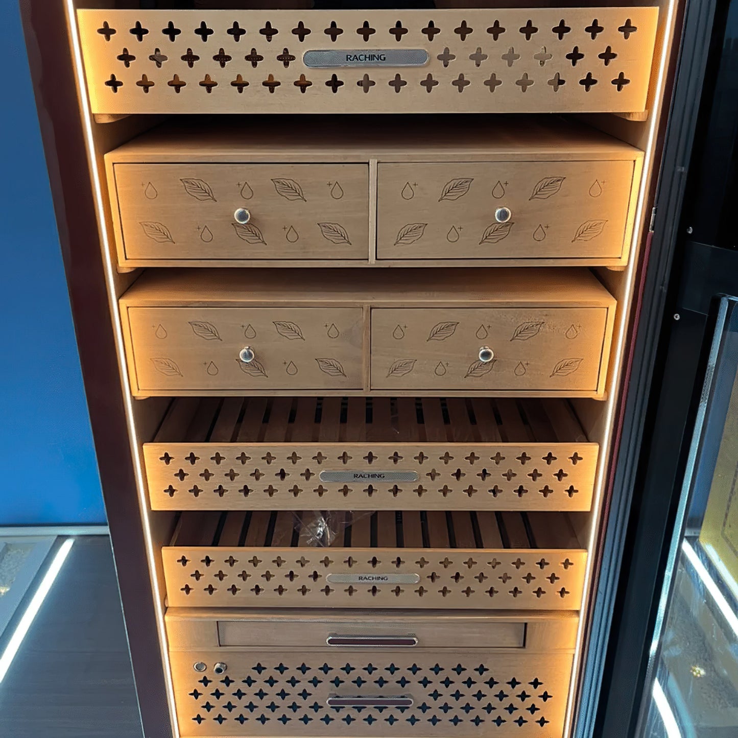 Real-world customer photo of the Raching RR980 humidor, demonstrating its impressive 73-inch height and premium presence in a home collection.