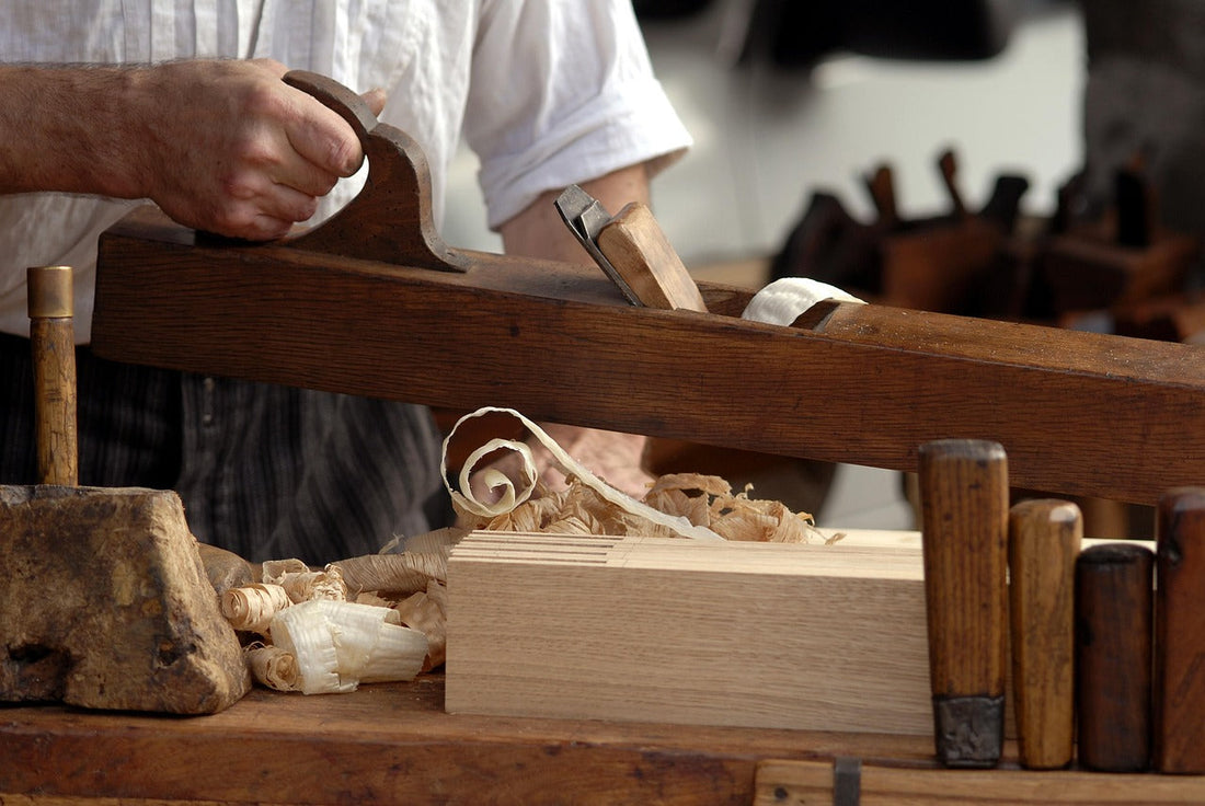 A man building a humidor cabinet from scratch in his woodworking studio. 