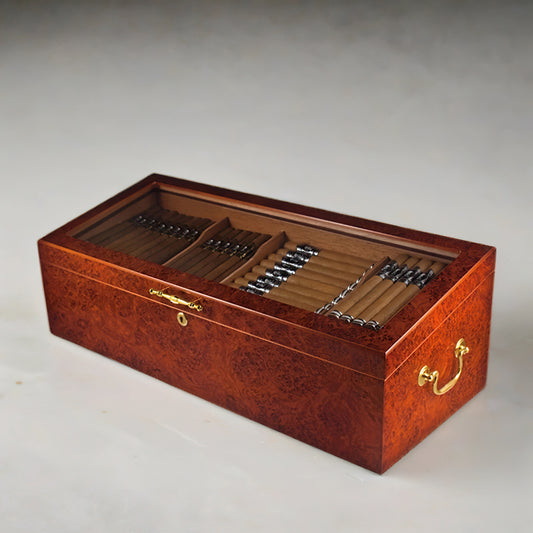 Countertop display humidor with burl finish, a glass top, and gold plated hardware accents