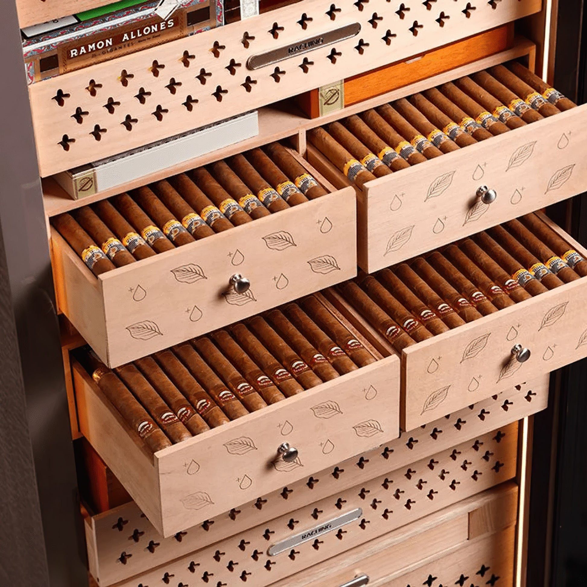 Close-up of RR980 Spanish cedar drawers stocked with premium cigars, highlighting the high-capacity tray design and moisture retention.