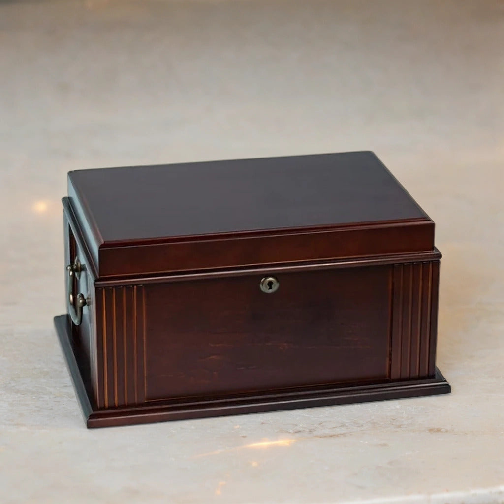 Wooden desktop humidor box on a reflective surface with a neutral background