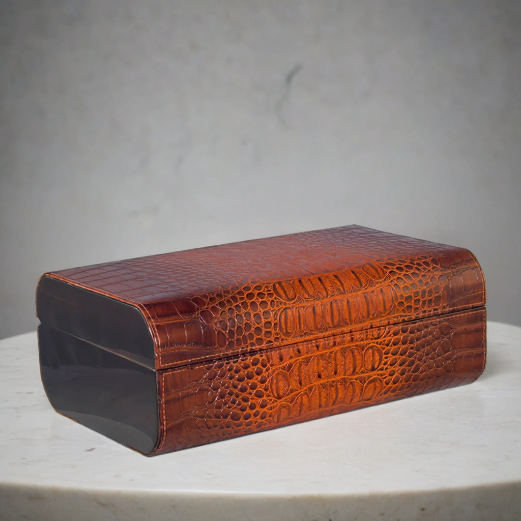 Brown crocodile-patterned leather desktop humidor on a gray background