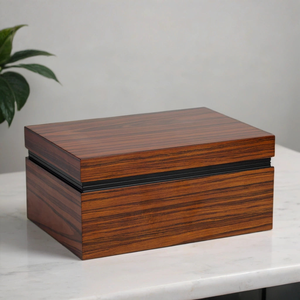 Desktop humidor with beautiful wooden finish on a white marble surface