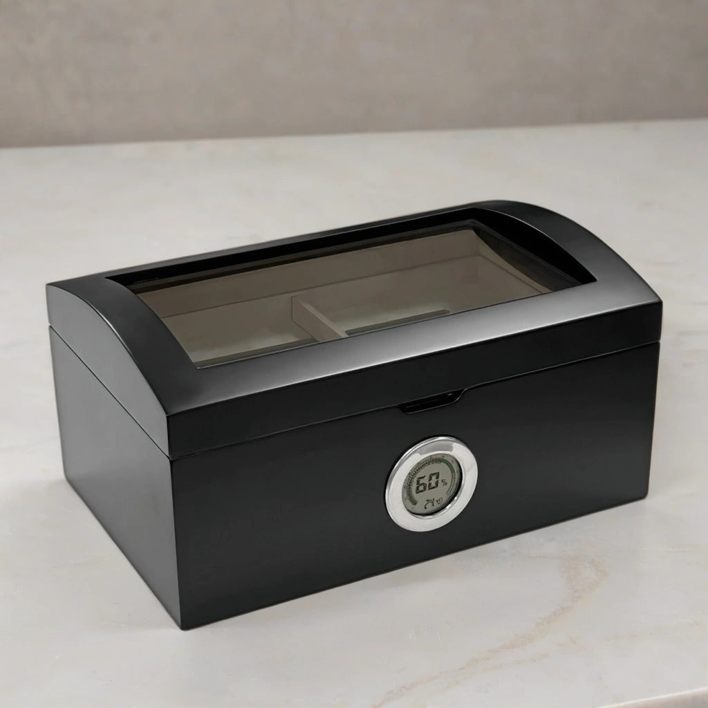 Desktop humidor with black exterior, a glass top, and a digital hygrometer