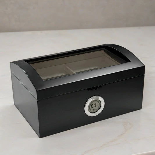 Desktop humidor with black exterior, a glass top, and a digital hygrometer