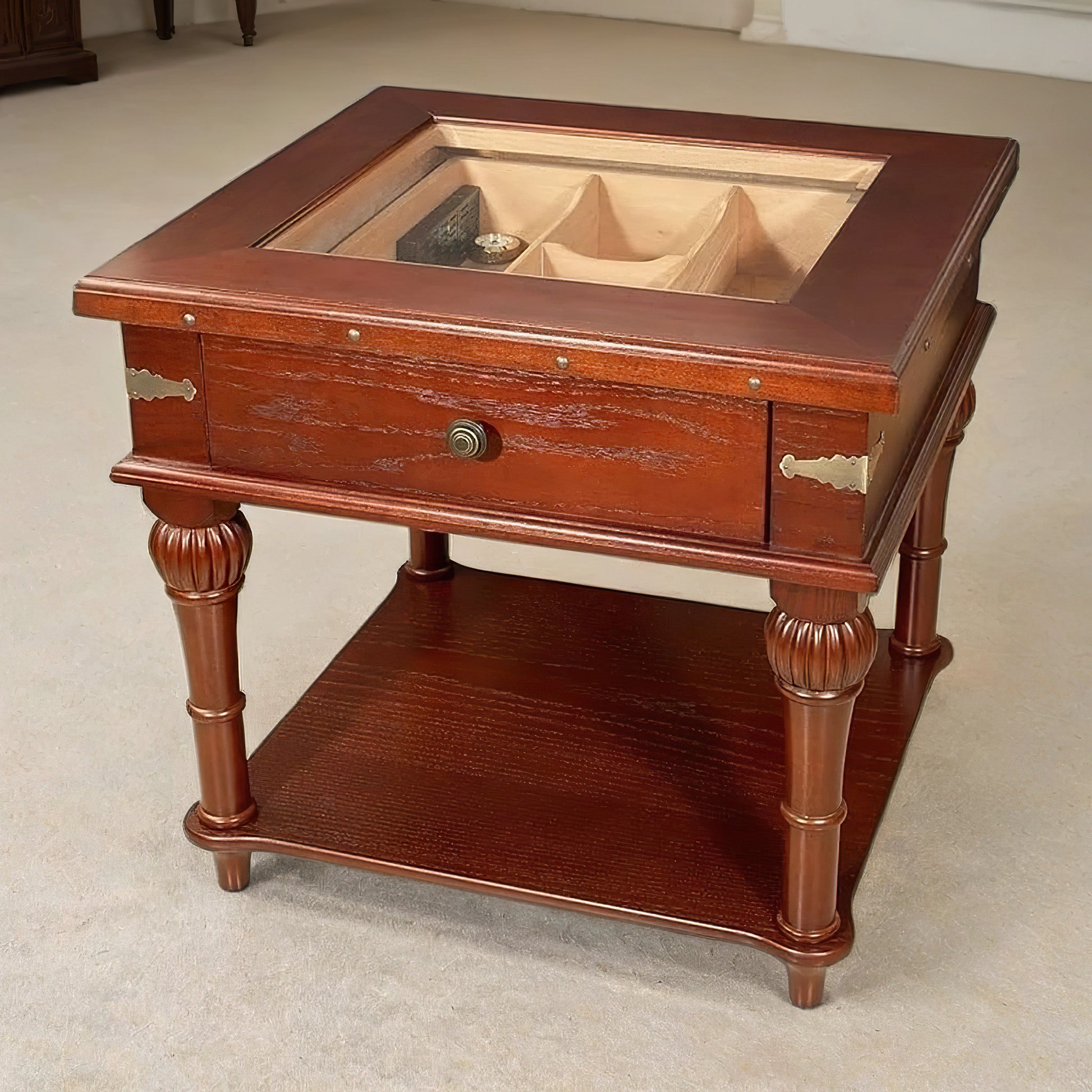 Wooden humidor table with glass top and storage compartments on a beige carpet.