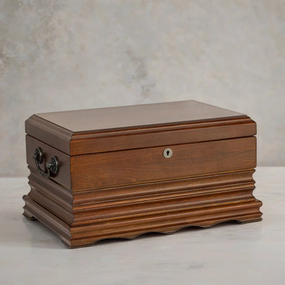 Wooden desktop cigar humidor with a textured surface on a neutral background