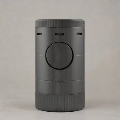 Tabletop cigar lighter with a gunmetal grey finish sitting flat on a neutral toned surface